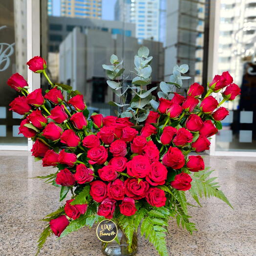 50 Stems of red roses beutifully arrange in a vase