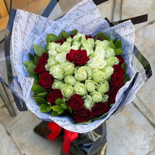 Bouquet of white and red roses and greenery