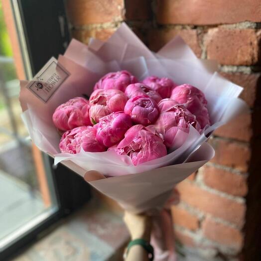A bouquet of 11 bright pink peonies in a designer package "Felix Supreme"