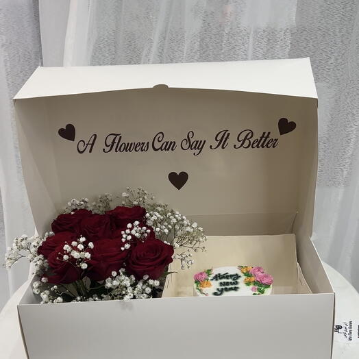 Flowers in a box with cake happy new year