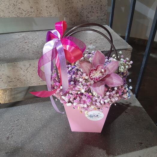 Gypsophila in a handbag with an orchid