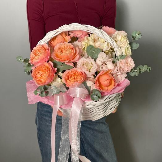 Basket with peony-shaped roses and seasonal flowers