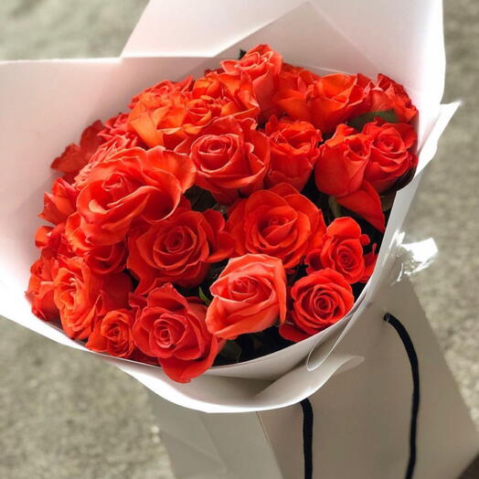 Radiant orange roses presented in a gift bag