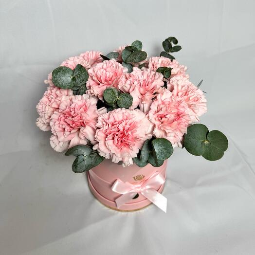 Delicate pink dianthuses in a hatbox