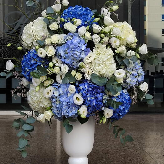 Elegant Fusion: Blue   White Hydrangeas arrangement 10 white lisianthus and 5 white spray roses with green fillers in a pot