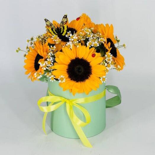 A bouquet of sunflowers in a hatbox