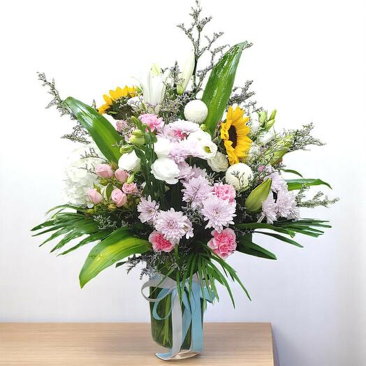 Sunlit harmony flowers in glass vase