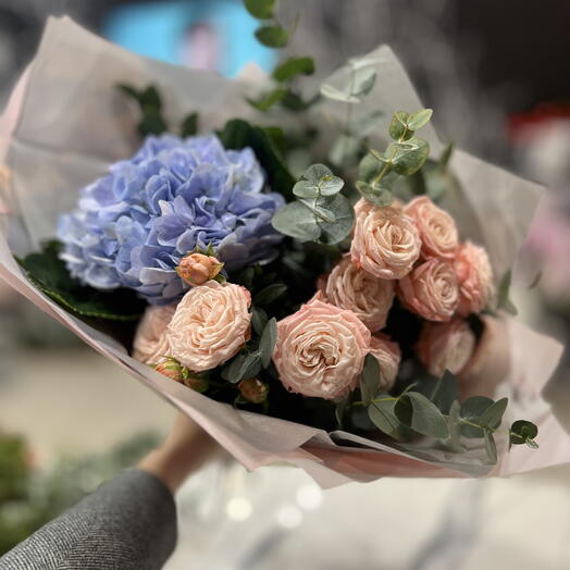 Bouquet with blue hydrangea and bush rose