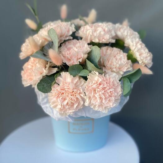 A composition of delicate carnations and eucalyptus