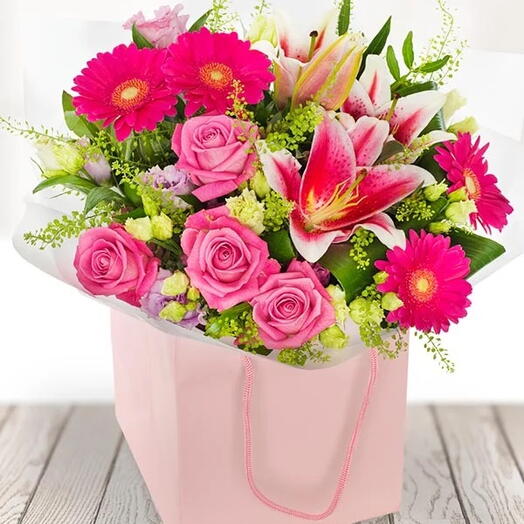 Pink Beauty: Hand-Crafted Arrangement of Pink Lilies, Purple Roses   Fuchsia Gerberas with Fillers