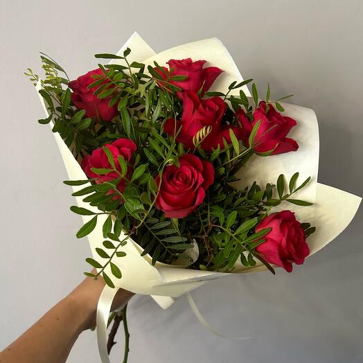 7 red roses with greenery
