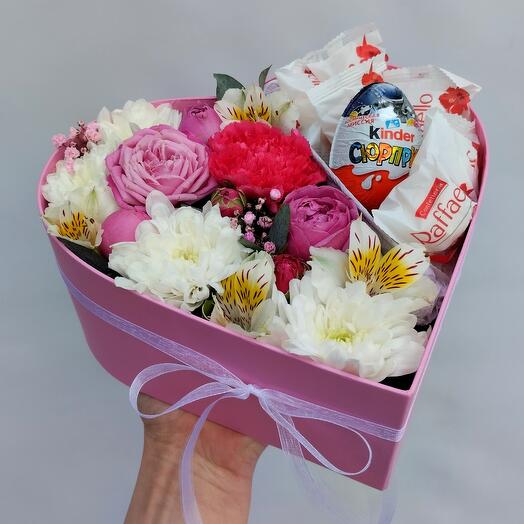 A compliment box with a heart of flowers and sweets