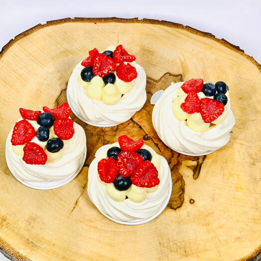 Gift box of Meringue nests with cream and fresh berries