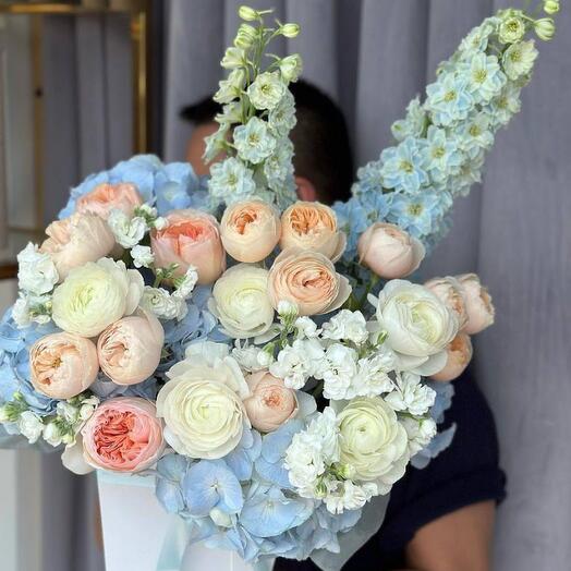 Bouquet of peony roses, hydrangeas and raniculus in a hatbox