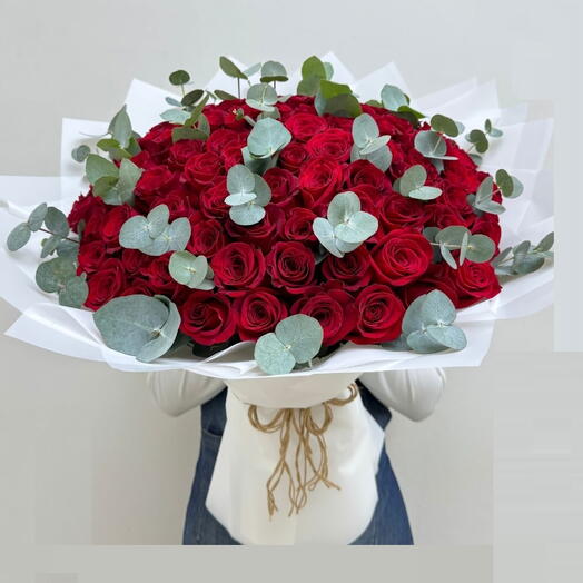 100 Red Roses and eucalyptus in bouquet with white wrapping