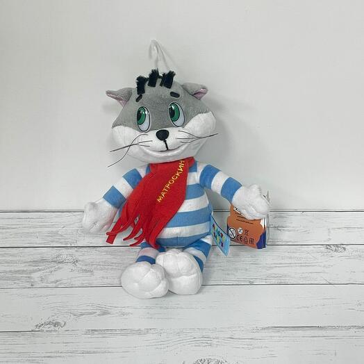 A soft Basik toy in a bright scarf