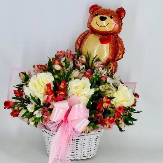 Alstroemeria flowers with white French roses and a bear balloon in a basket