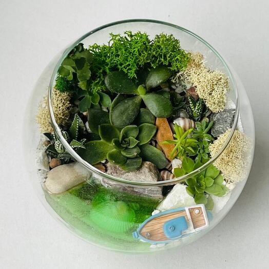 A mini garden with flowers and a boat in the ocean