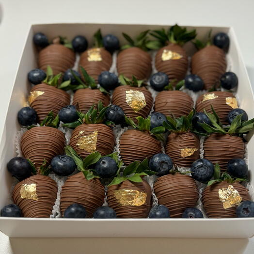 Strawberries in milk chocolate with blueberries