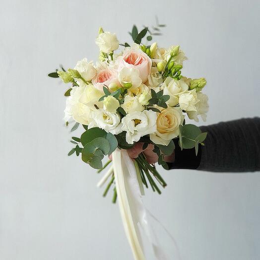 The bride's delicate wedding bouquet of roses and greenery is an affectionate rebellion