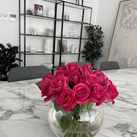 Fucsia roses in glass vase
