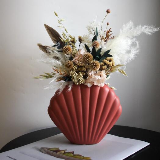 Composition in terracotta color in a vase "shell"