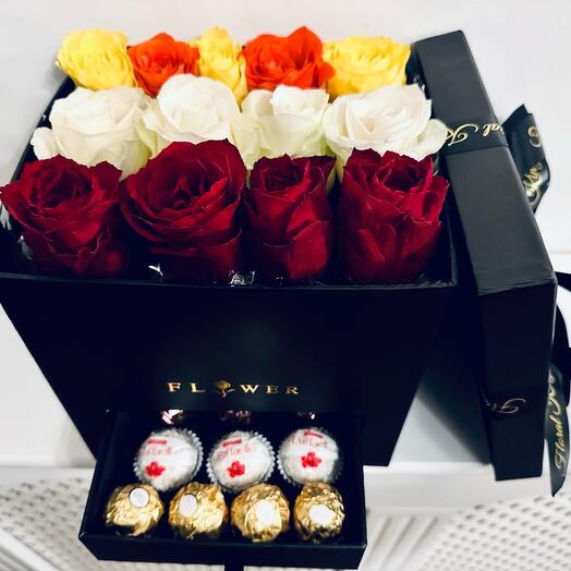 Flowers in a black box with chocolates
