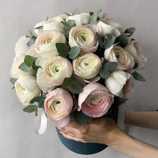 Bouquet of ranunculus with eucalyptus in a hat box