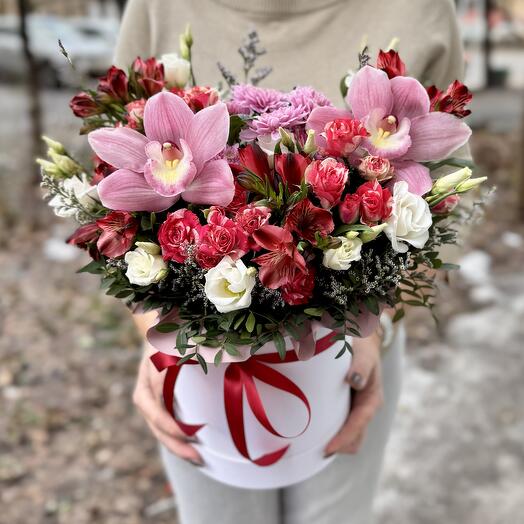 Flowers with orchids and bush roses in a box