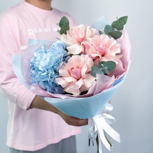 Delicate bouquet of blue hydrangea with pink French roses and eucalyptus