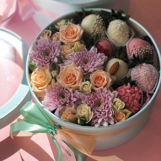 Flowers with strawberries in chocolate in a box