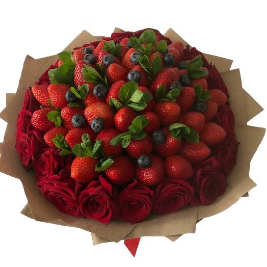 Bouquet of red roses with fresh strawberries in the middle